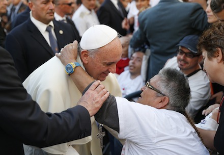 Woman in wheelchair embraces pope during encounter with youth in Cagliari, Sardinia