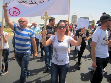 Christian refugees march against persecution by Islamic State fighters in Iraq